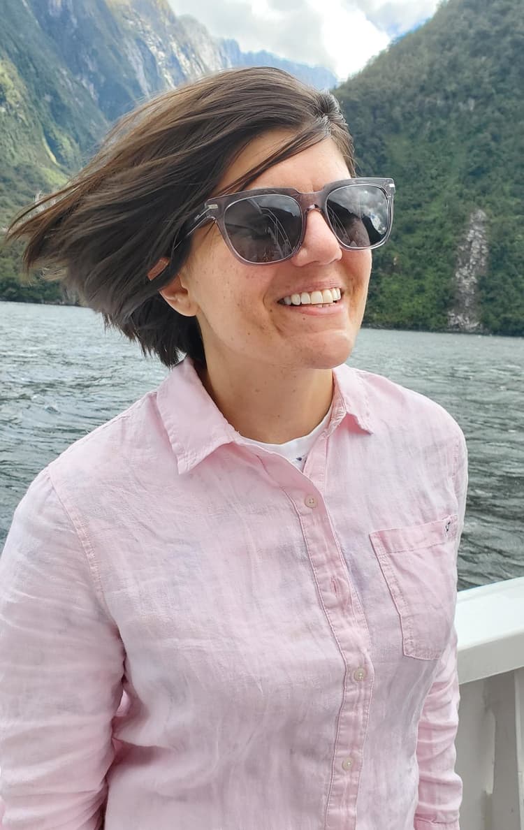 Gina enjoying the sea spray at Milford Sound